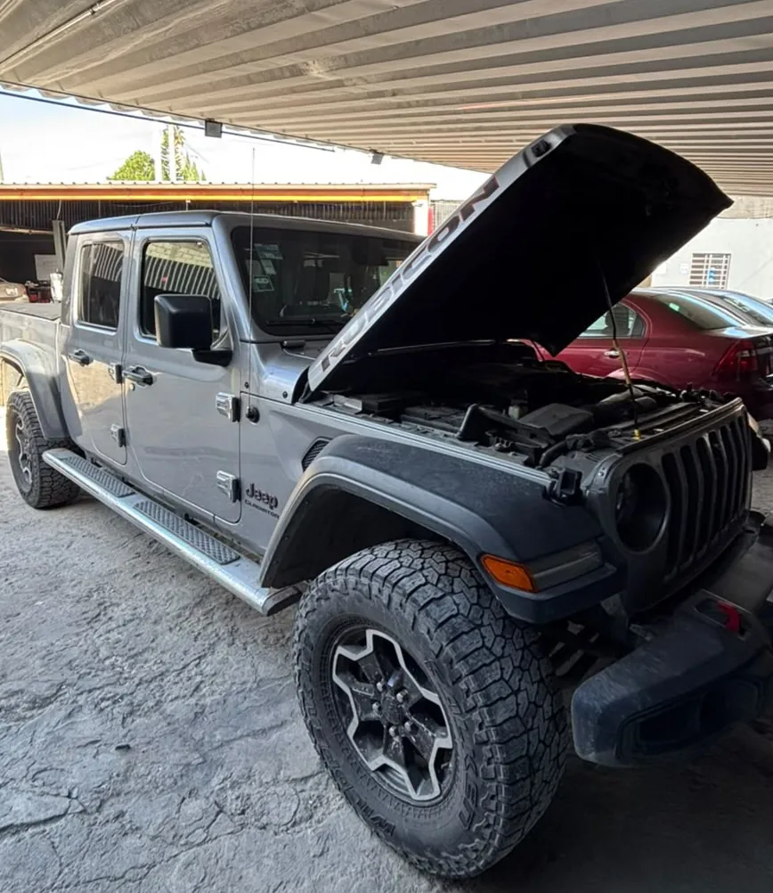 Jeep con el cofre abierto en el taller